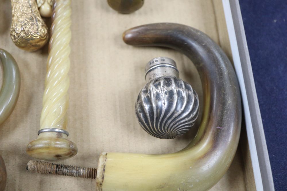 A group of silver, gilt metal and ivory walking cane and parasol handles.